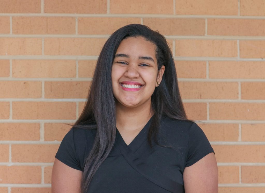 A student smiles for a photo