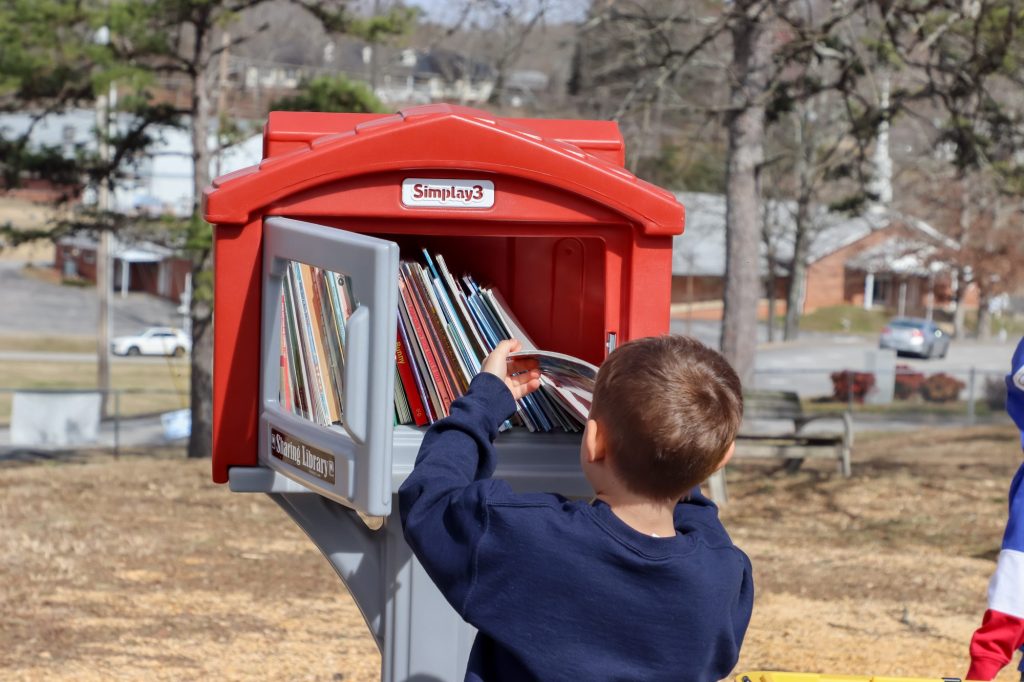 A student reaches for a book