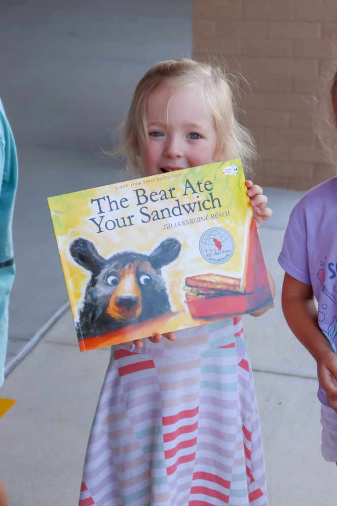 smiling student holding book