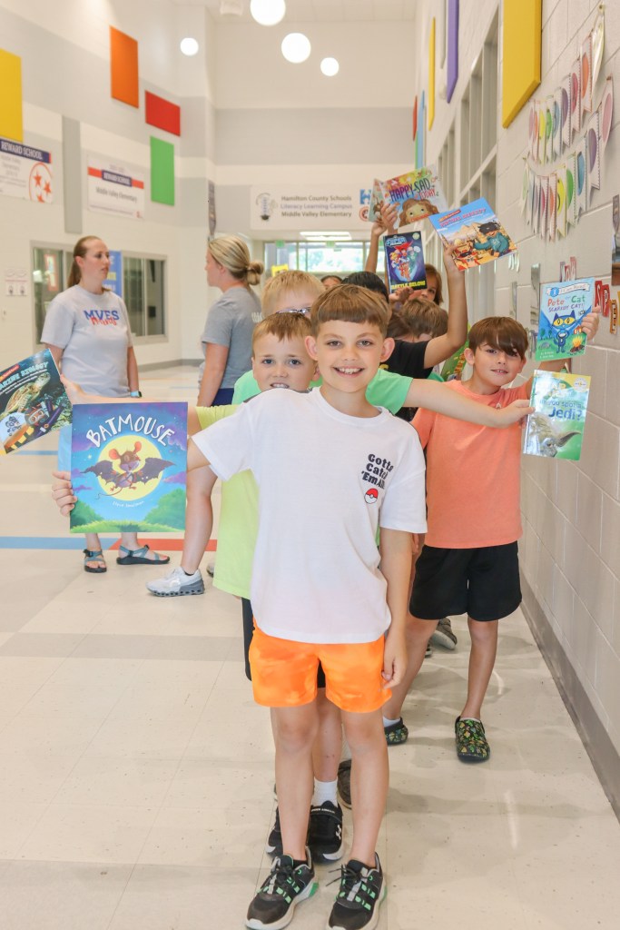 students holding books
